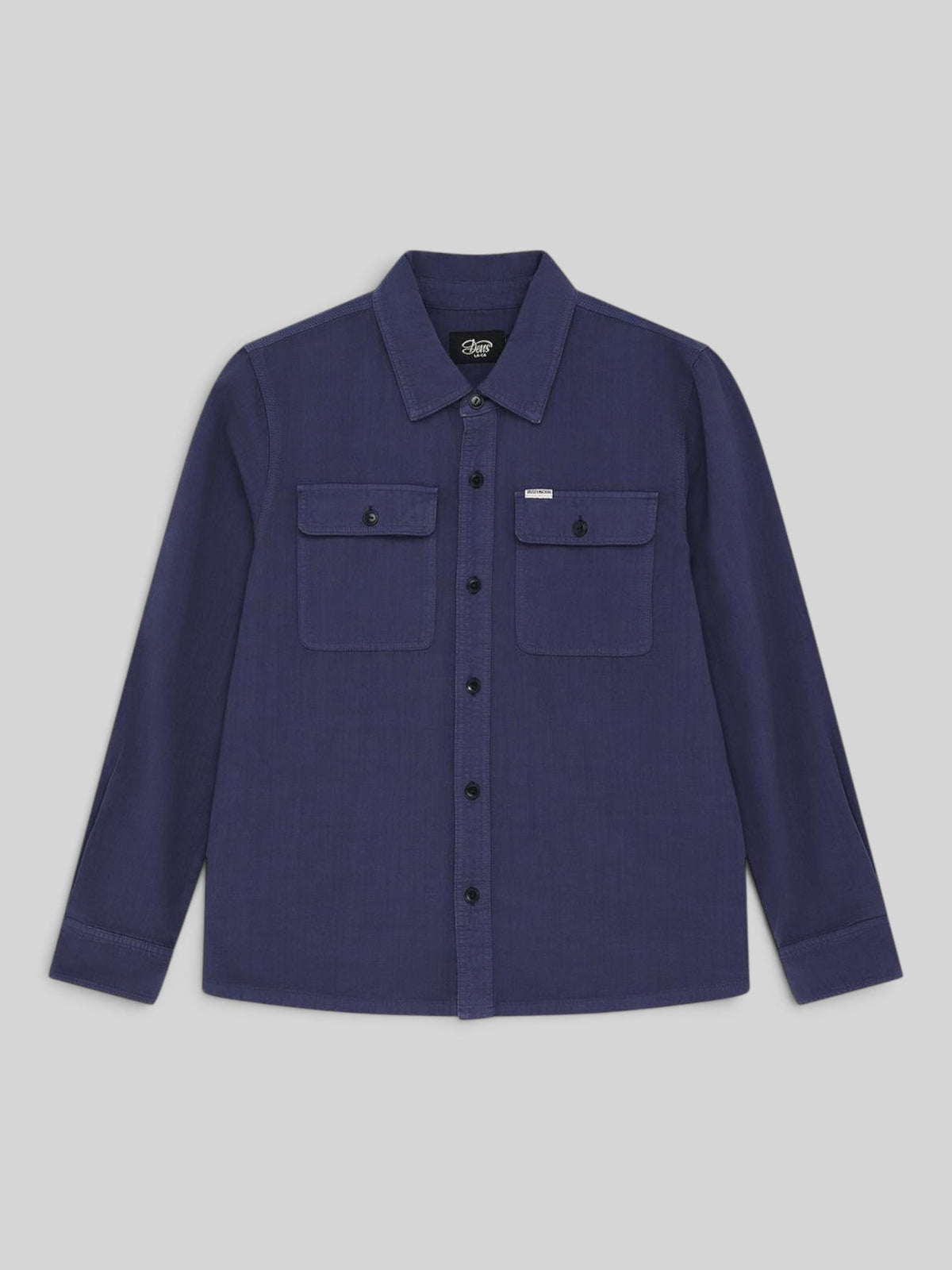 Baffle Haus Vacay Chambray Shirt in mechanic blue with chest flap pockets and corozo nut buttons.