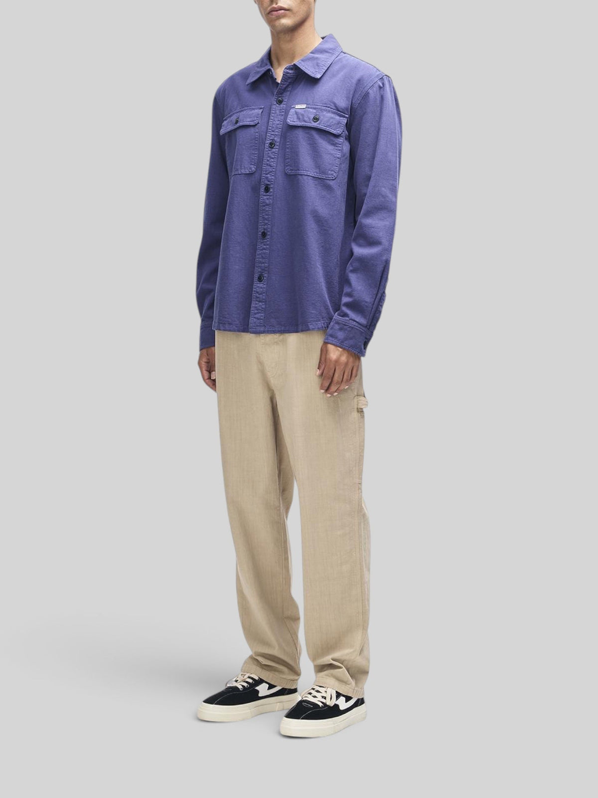 Baffle Haus Vacay Chambray Shirt in mechanic blue with chest flap pockets and button closure on a male model