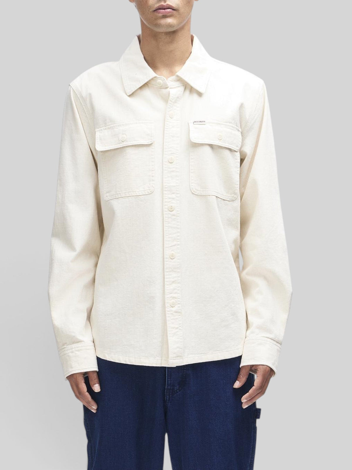 Baffle Haus Vacay Chambray Shirt in natural cotton with chest flap pockets and button closure on a male model