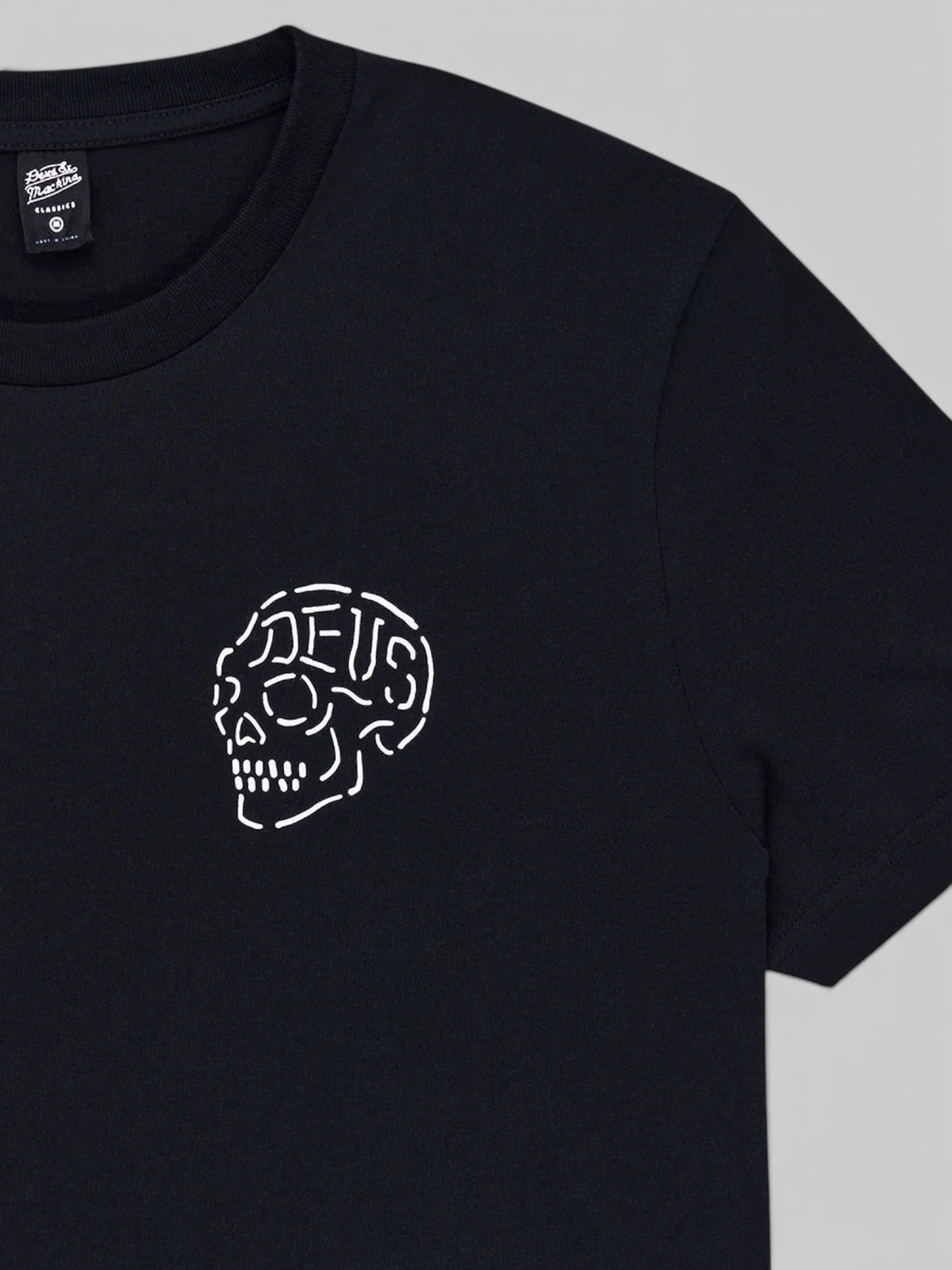 Baffle Haus Venice Skull Tee in black organic cotton with a white line-art skull graphic on the chest.