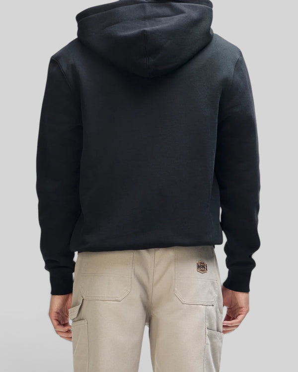 Baffle Haus Victory Lap black zip hoodie worn by a model, back view showing the hood and ribbed cuffs.