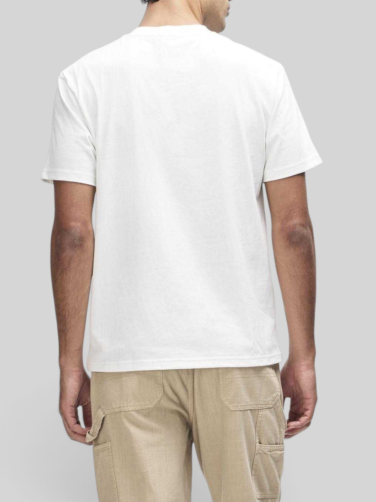 Back view of a Baffle Haus vintage white box fit short sleeve t-shirt worn with beige cargo pants