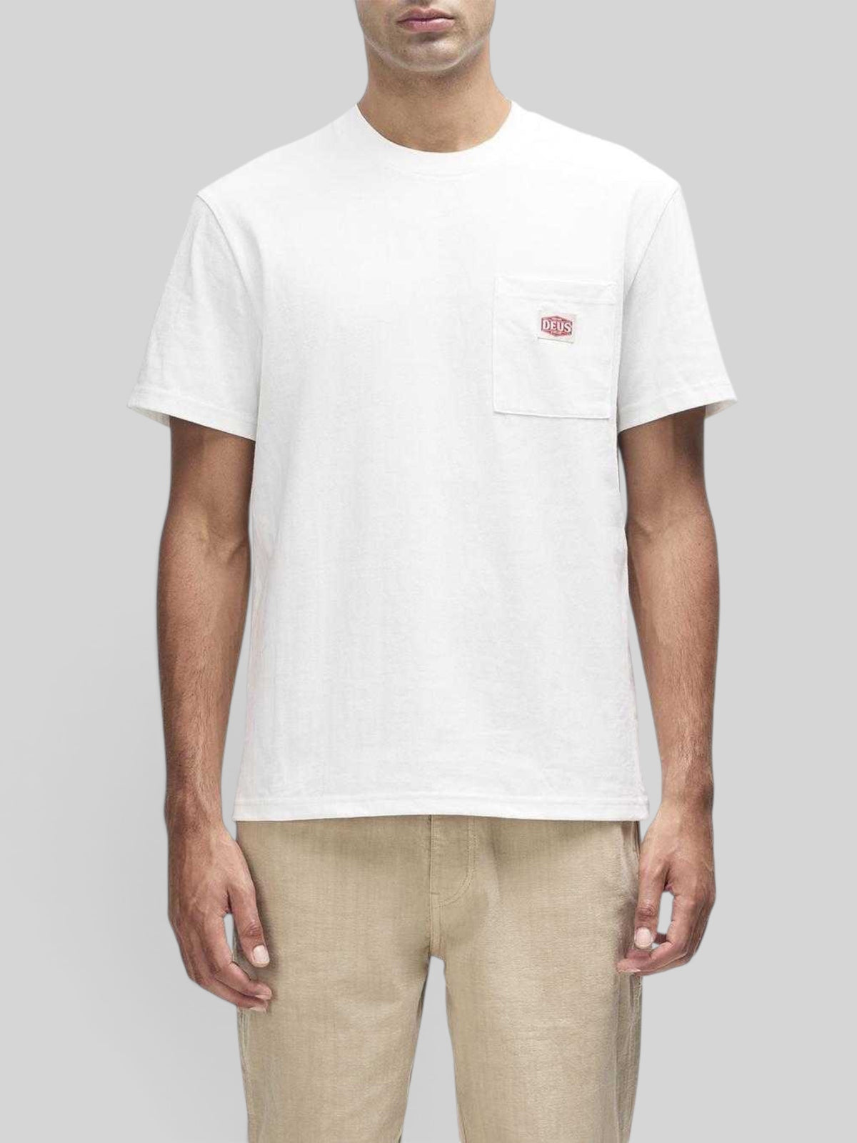 Baffle Haus vintage white box fit short sleeve t-shirt with a chest pocket and branded label on a male model