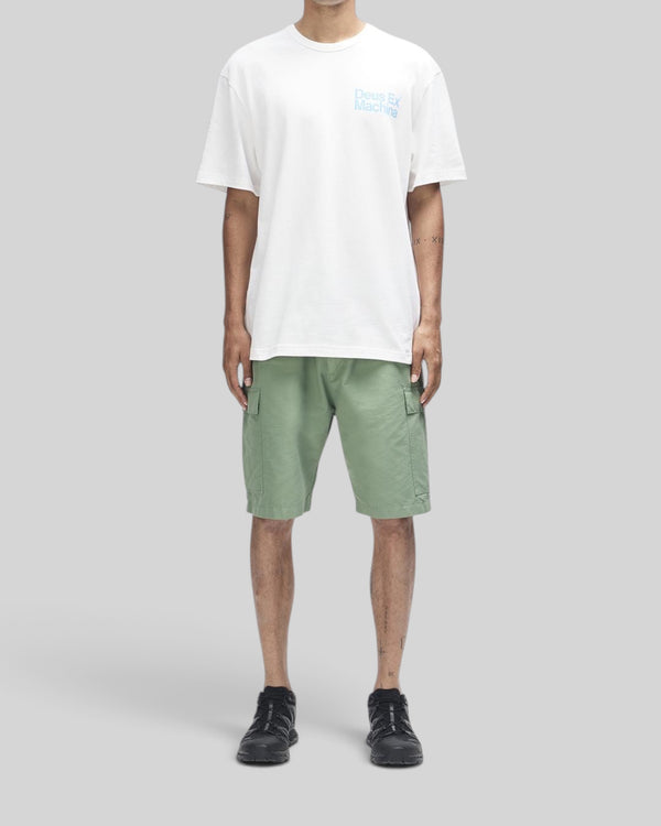 Baffle Haus Plenty Good Tee in vintage white with chest print, worn with green cargo shorts and black sneakers.