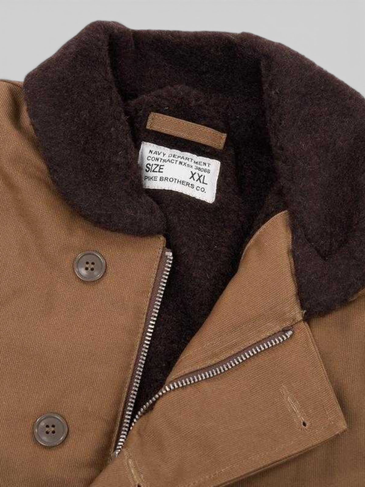 Baffle Haus 1944 N1 Deck Jacket in waxed khaki cotton with a dark brown wool collar and vintage Talon zipper detail.