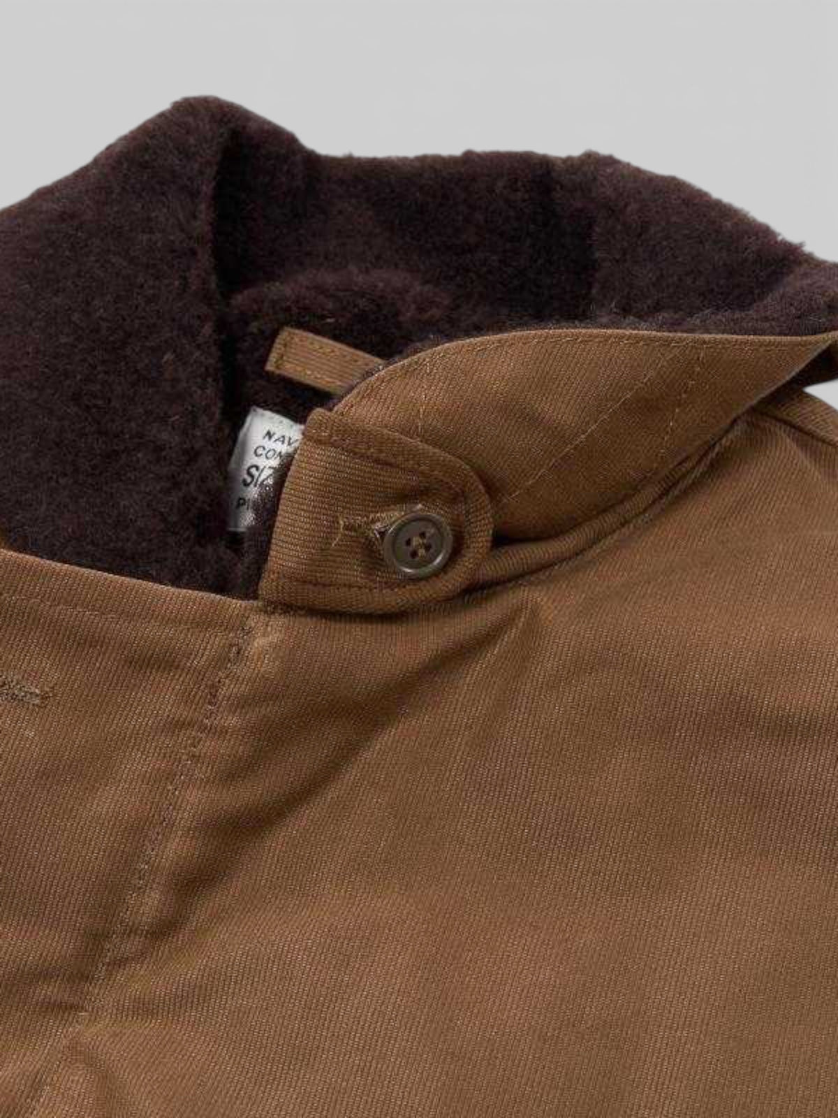 Baffle Haus 1944 N1 Deck Jacket in waxed khaki cotton with a dark brown wool collar and authentic spec label