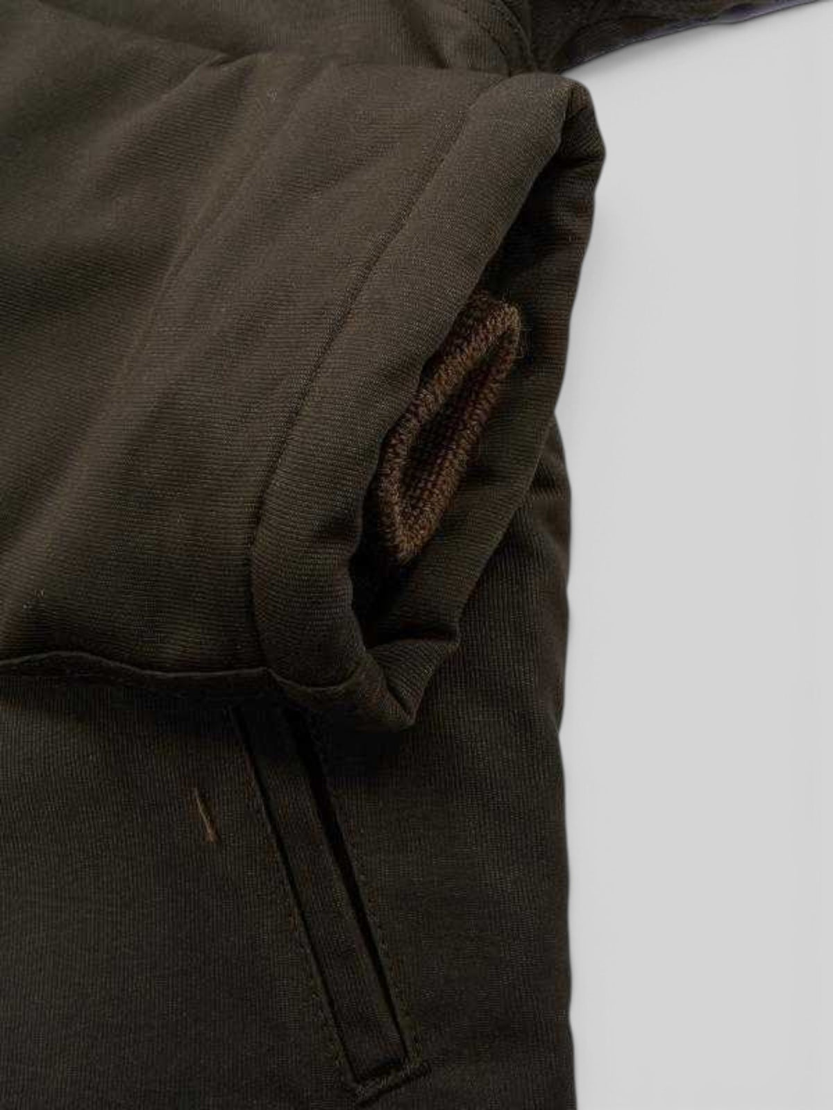 Baffle Haus olive waxed cotton N-1 deck jacket sleeve detail showing the ribbed knit wind cuff