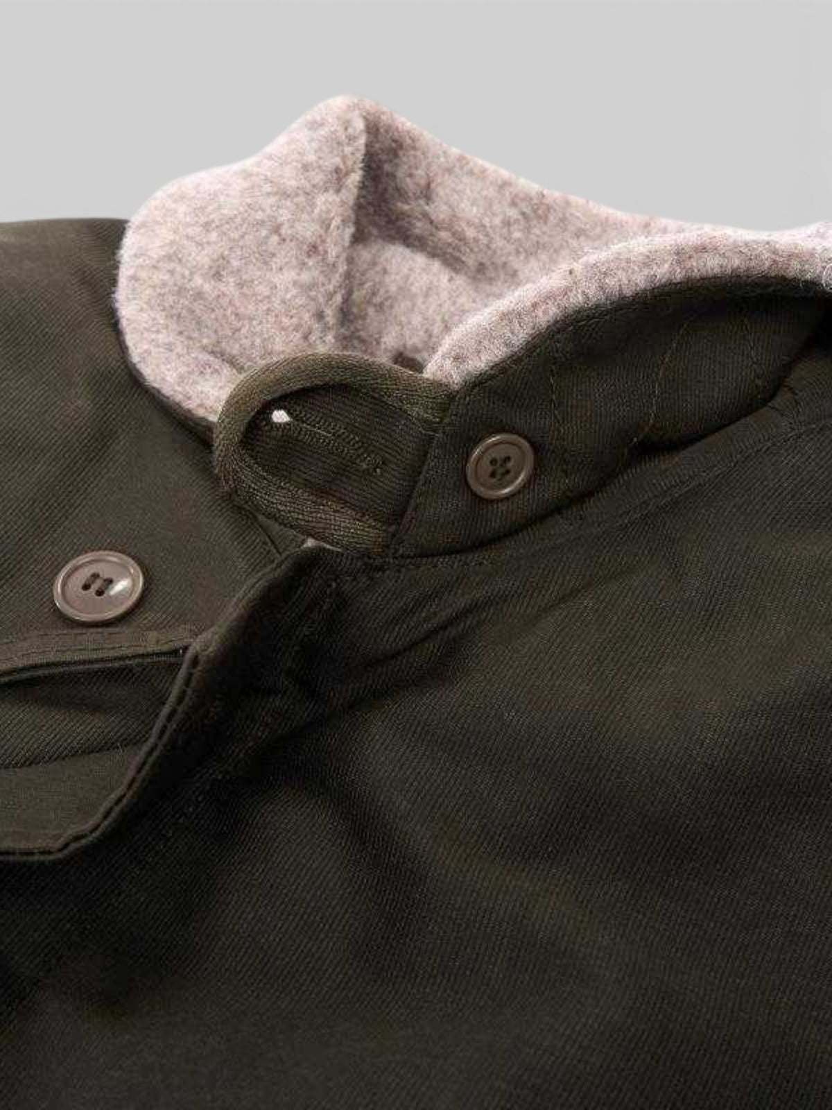 Baffle Haus 1944 N1 Deck Jacket in waxed olive cotton with a warm wool-lined collar and button-up storm flap.