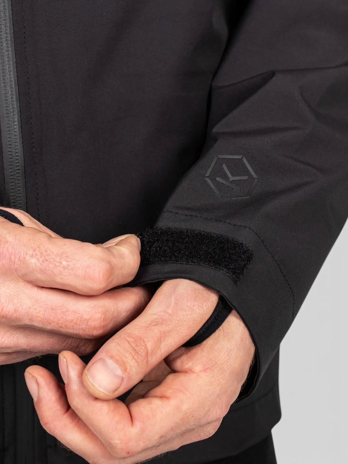 Baffle Haus Welbeck MK2 waterproof motorcycle overjacket in black featuring adjustable velcro cuff closure
