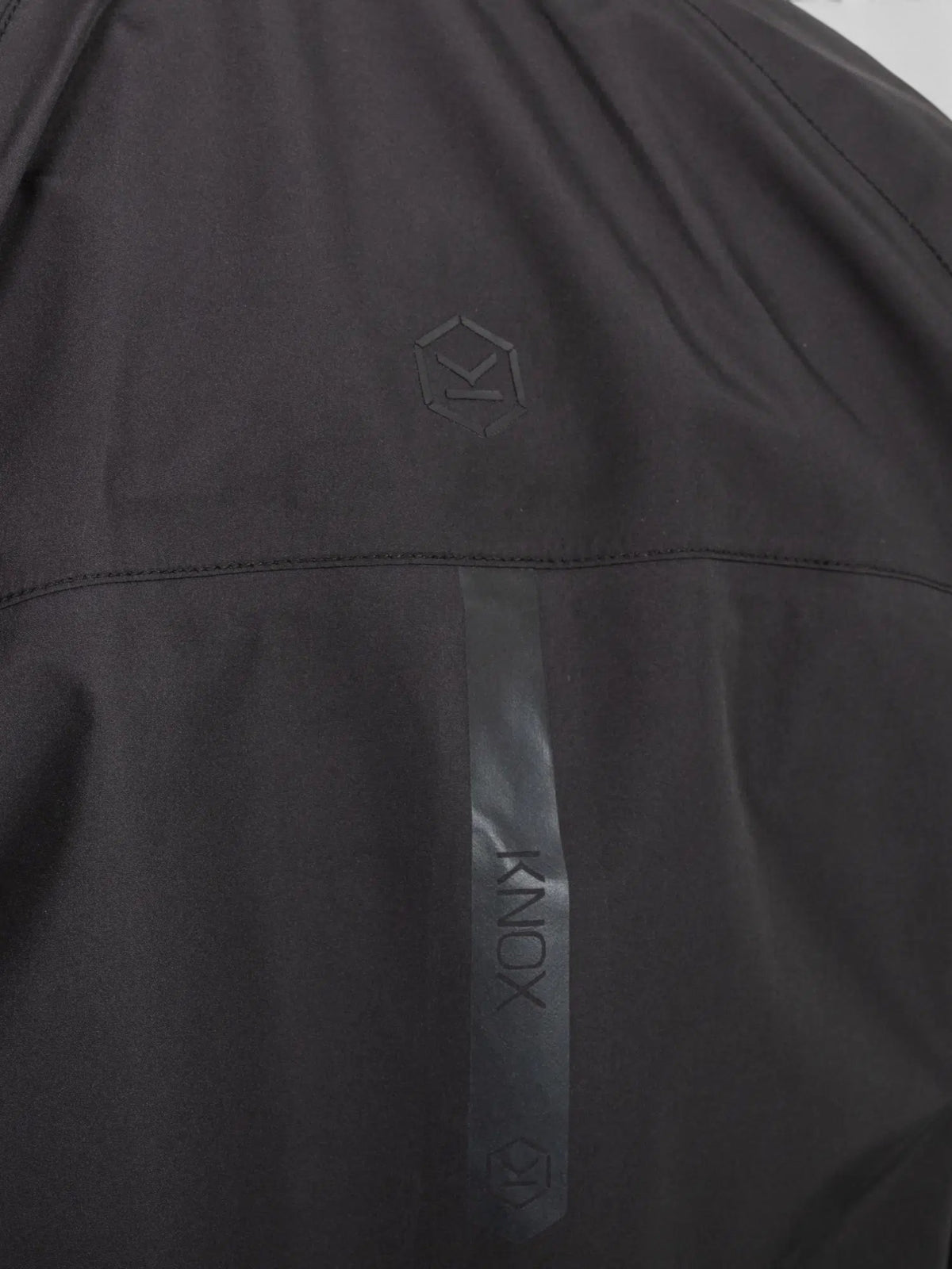 Baffle Haus Welbeck MK2 waterproof motorcycle jacket in black featuring a subtle Knox logo and reflective detailing.