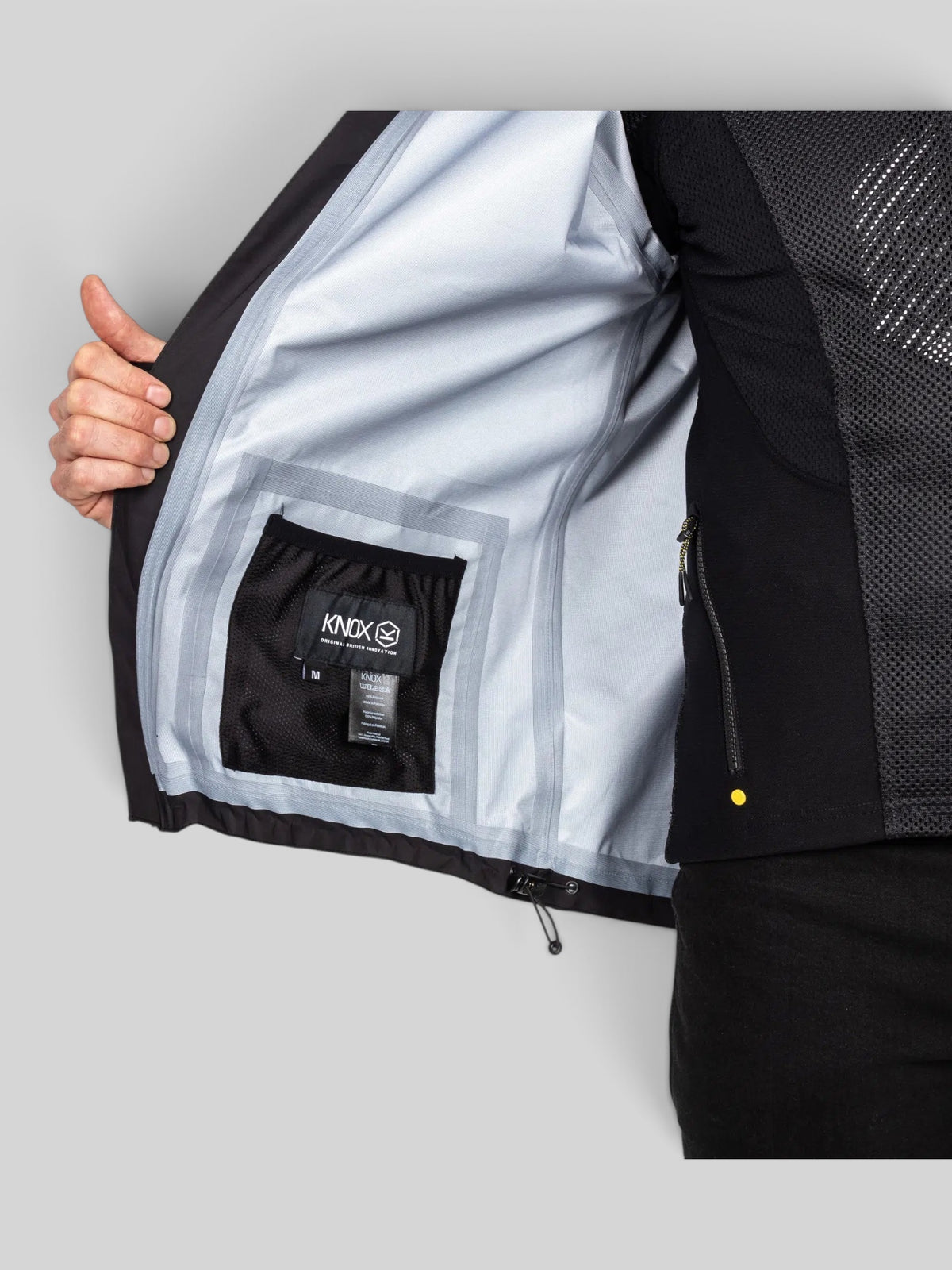 Baffle Haus Welbeck Waterproof Overjacket MK2 interior view showing seam-sealed fabric, mesh pocket, and Knox branding.