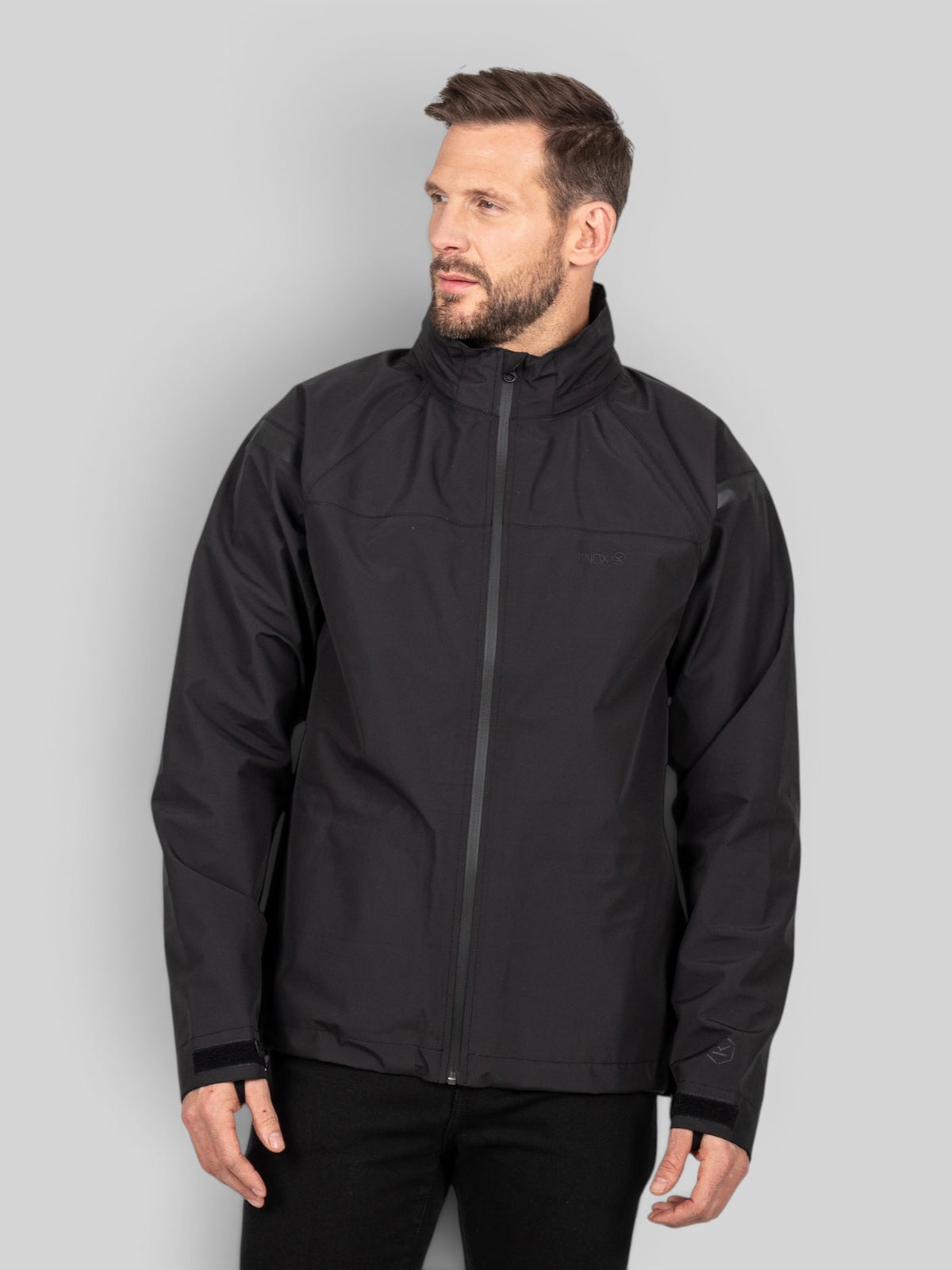 Baffle Haus Welbeck MK2 black waterproof motorcycle overjacket with high collar and seam-sealed tri-laminate fabric.