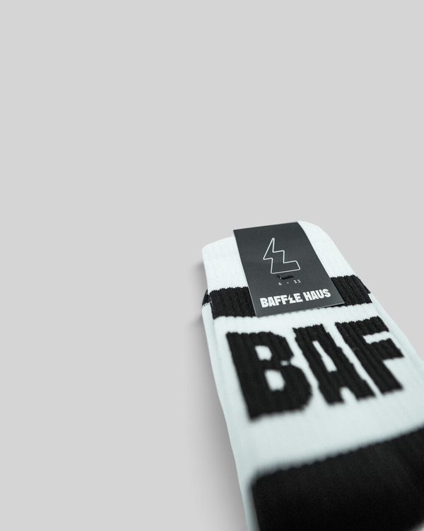 Baffle Haus white crew socks with black branding and ribbed upper, featuring a cushioned sole for daily comfort.