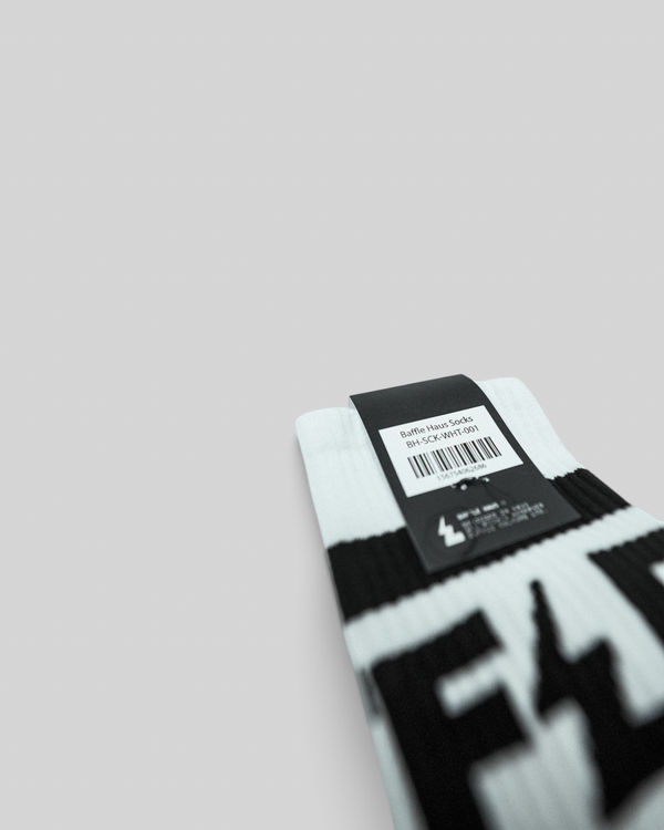 Baffle Haus white crew socks with black branding on a ribbed upper and a cushioned sole for everyday comfort.