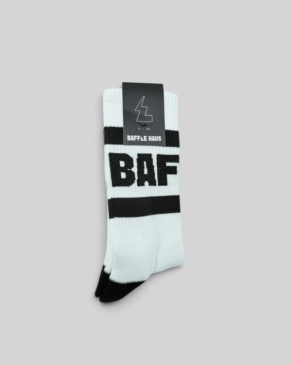 Baffle Haus white crew socks with black stripes and bold BAF branding, featuring a ribbed upper and cushioned sole.