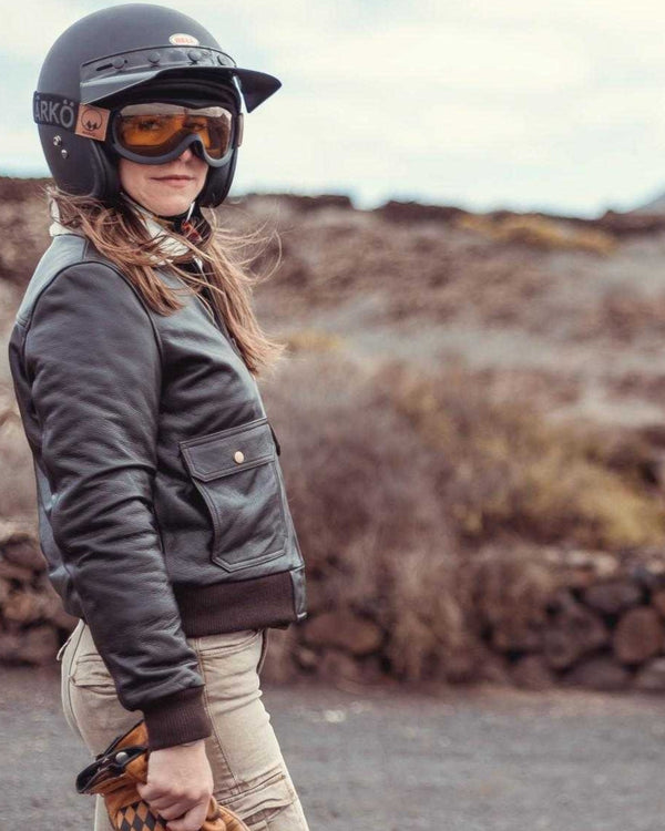 Baffle Haus Wildust women's dark brown cowhide leather aviator jacket with sherpa collar worn by a female motorcyclist