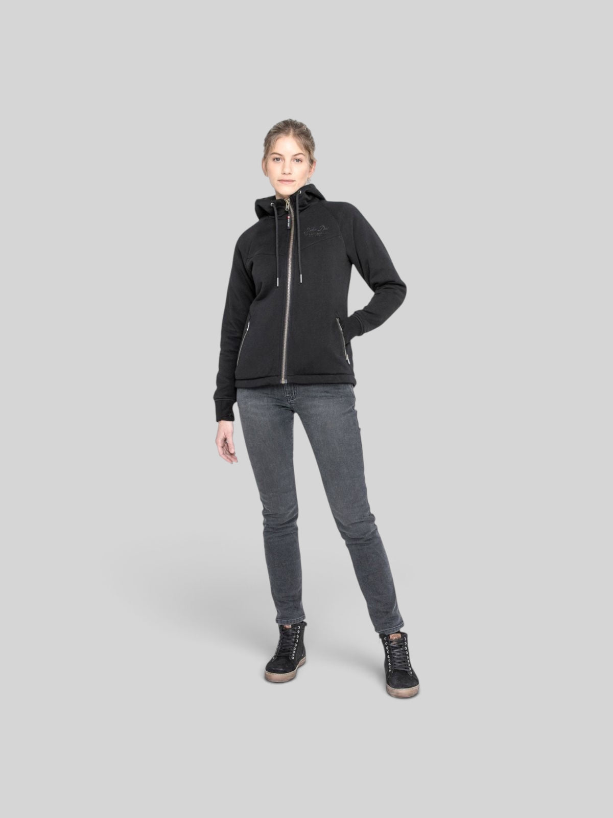 Baffle Haus women's black protective motorcycle hoodie with XTM lining, zippered pockets, and a tapered fit.