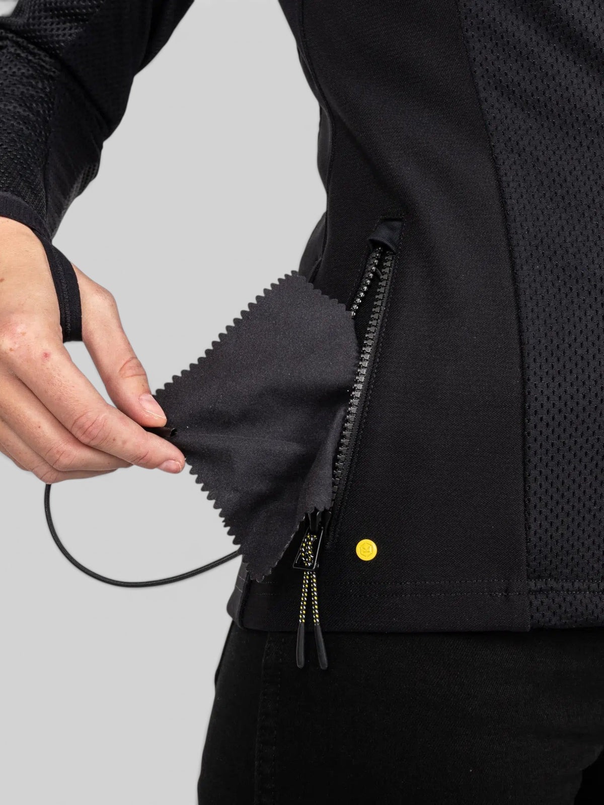 Baffle Haus Womens Urbane Pro MK3 black motorcycle jacket showing a close-up of the practical front zipped pocket