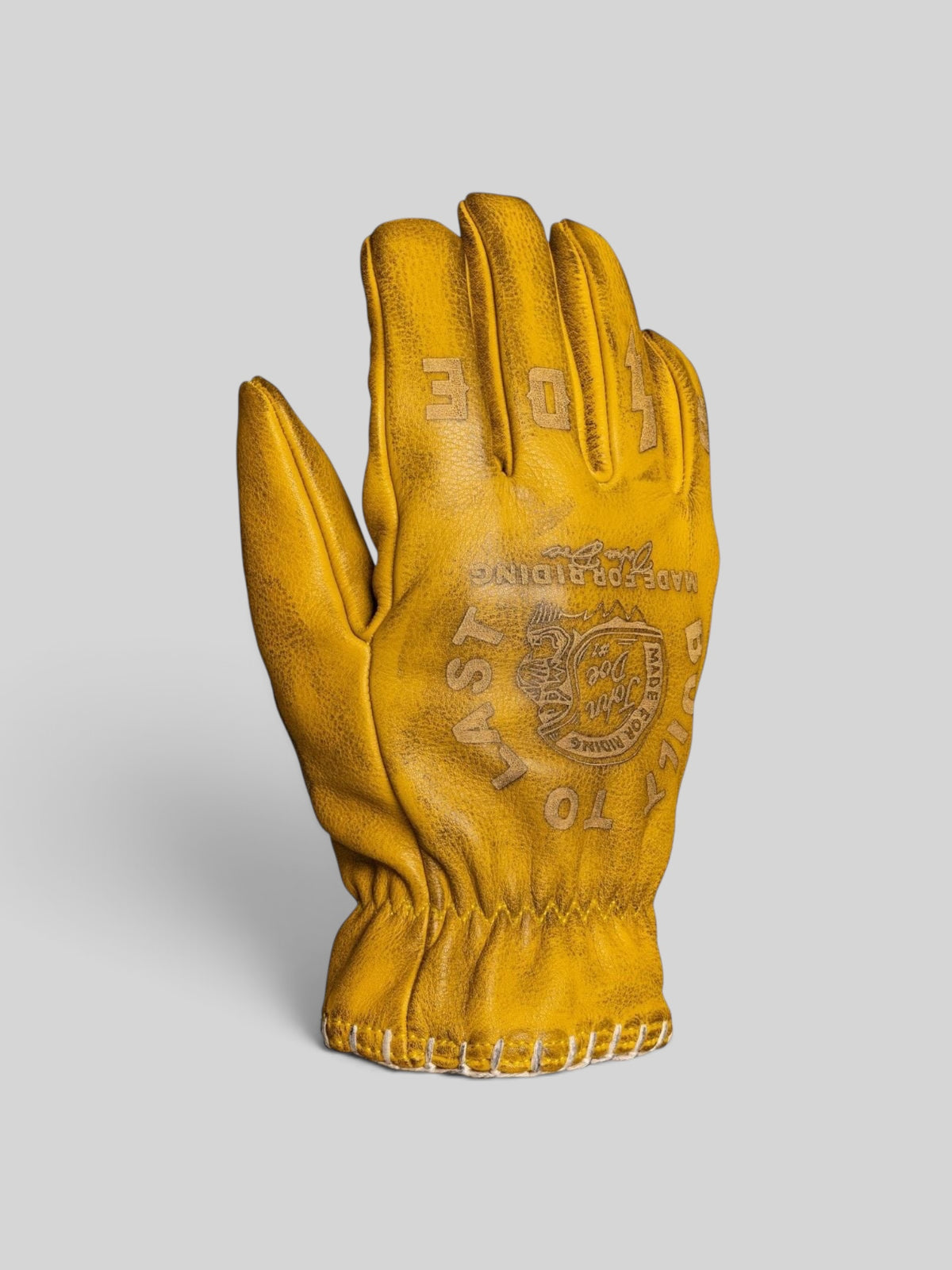 Baffle Haus yellow cowhide leather riding gloves with pre-curved design, stitched detailing, and press-stud cuffs.