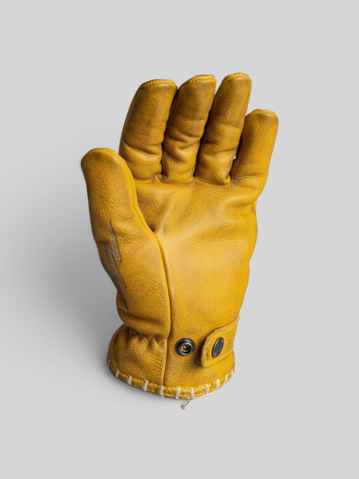 Baffle Haus yellow cowhide leather riding gloves with pre-curved fingers and adjustable press-stud cuffs.