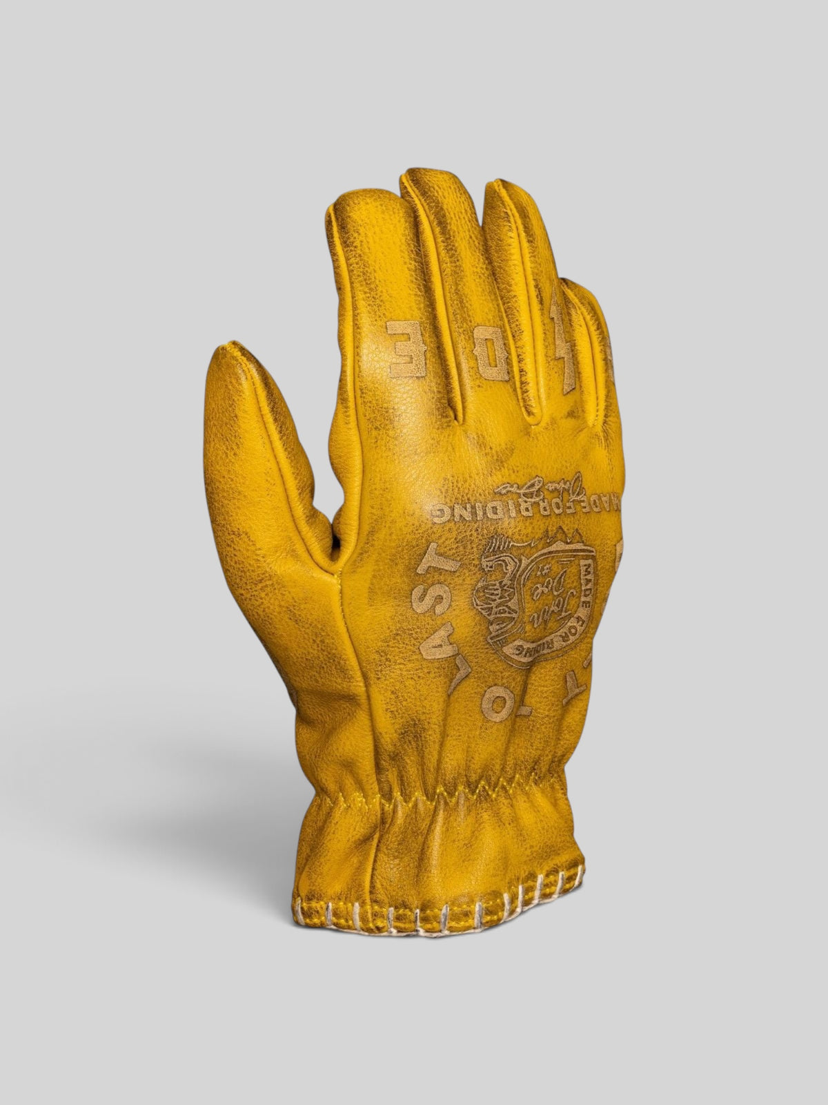 Baffle Haus yellow cowhide leather motorcycle gloves with pre-curved fit, stitched detailing, and embossed branding.