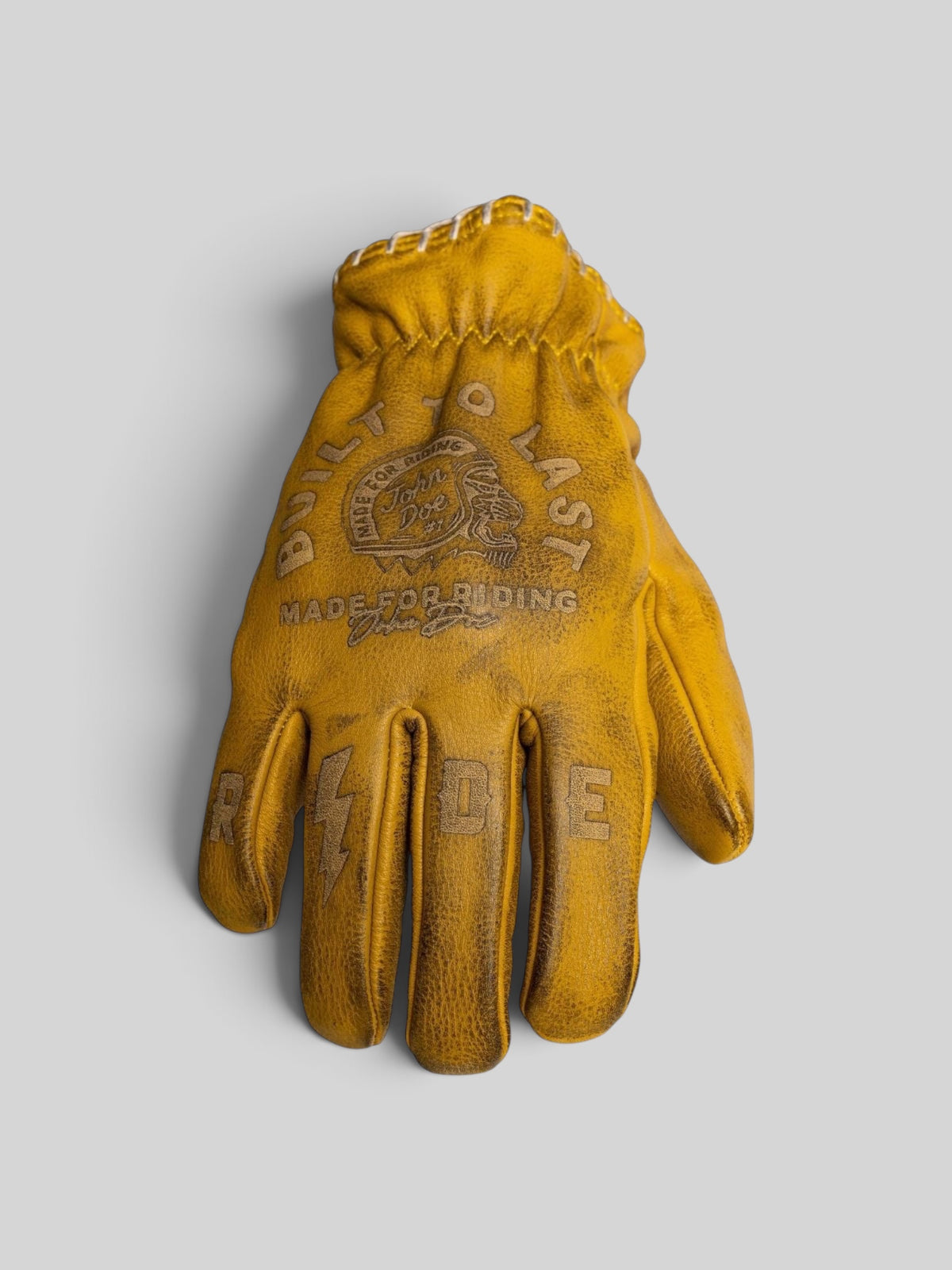 Baffle Haus yellow cowhide leather motorcycle gloves with pre-curved fit, stitched detailing, and embossed graphics.