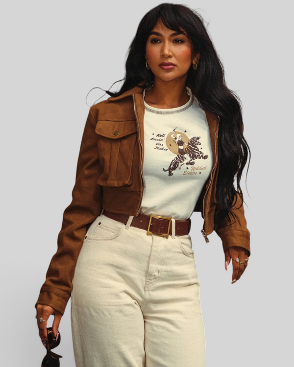 Baffle Haus white cropped cotton t-shirt with tiger rider graphic print worn under a brown suede jacket