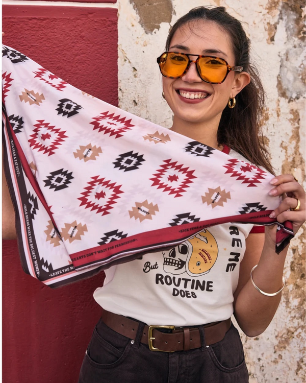 Baffle Haus Apache motorcycle scarf with geometric western pattern in beige, terracotta, and brown worn by a woman