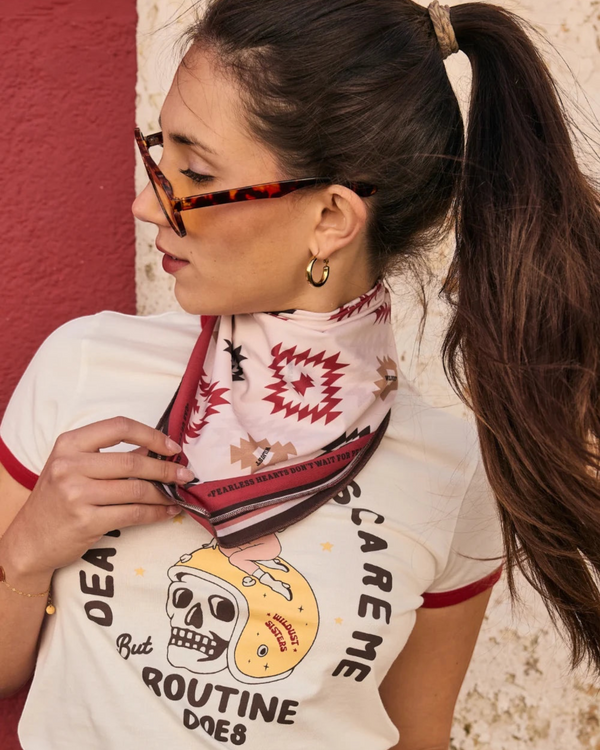 Baffle Haus Apache motorcycle scarf in beige and terracotta with geometric western print worn as a neck bandana