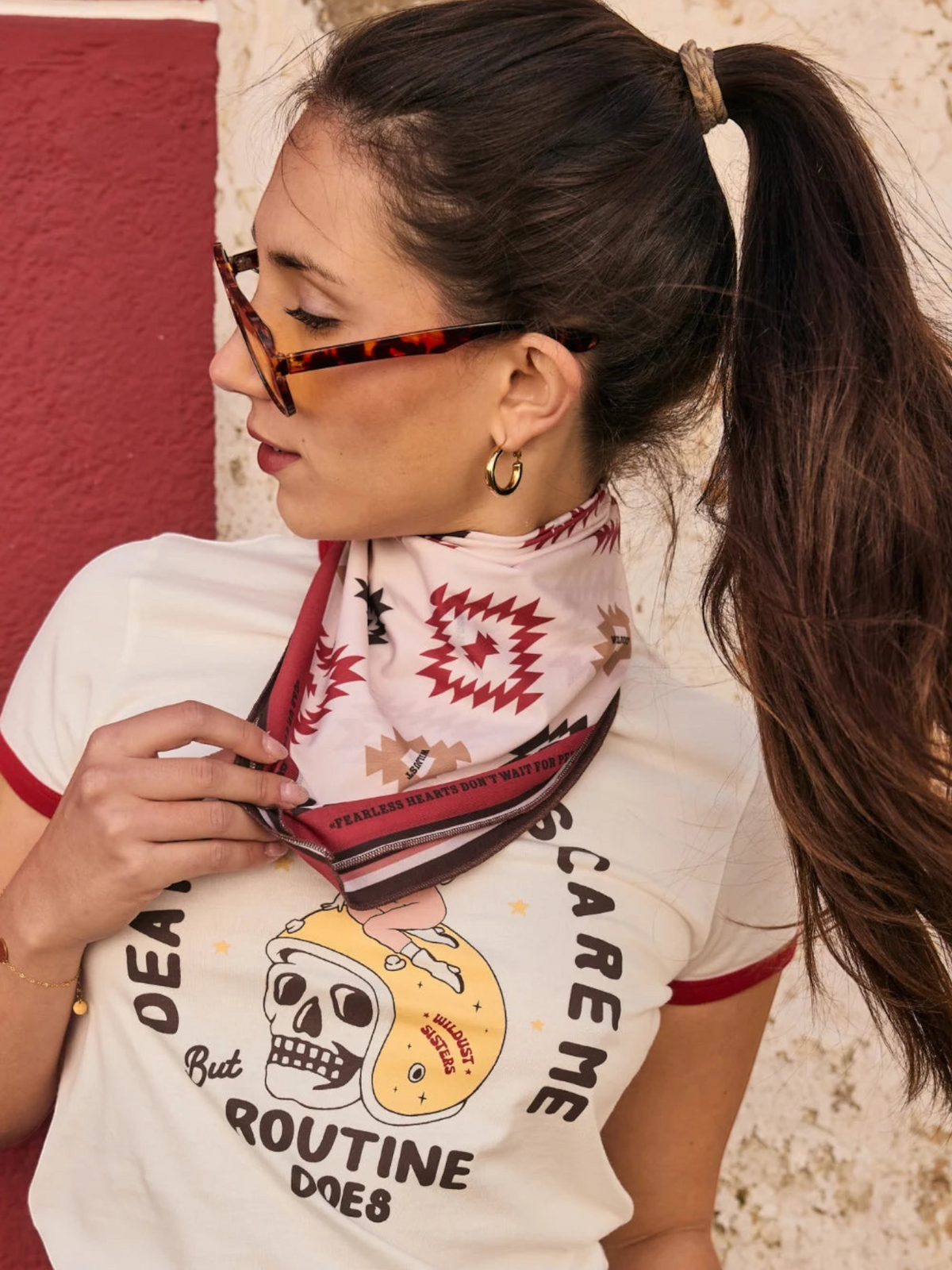 Baffle Haus Apache motorcycle scarf in beige and terracotta with geometric western print worn as a neck bandana
