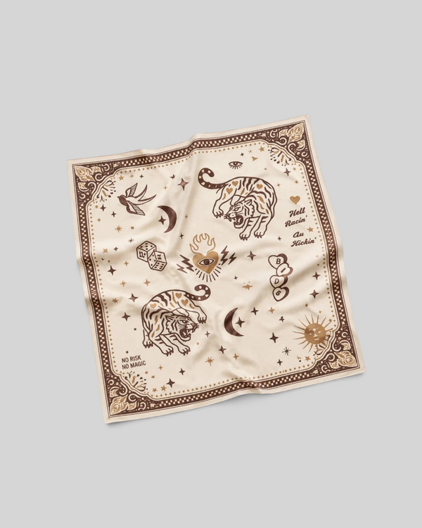 Baffle Haus Moon Rider beige lycra motorcycle scarf with brown tiger, celestial, and tattoo-inspired graphic prints.