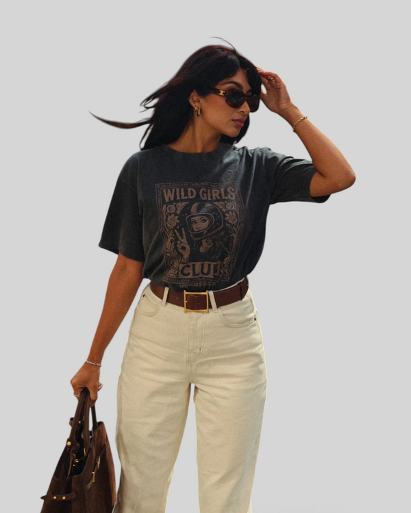 Baffle Haus Wild Girls Club grey washed cotton t-shirt with retro biker graphic print worn by a woman in cream jeans