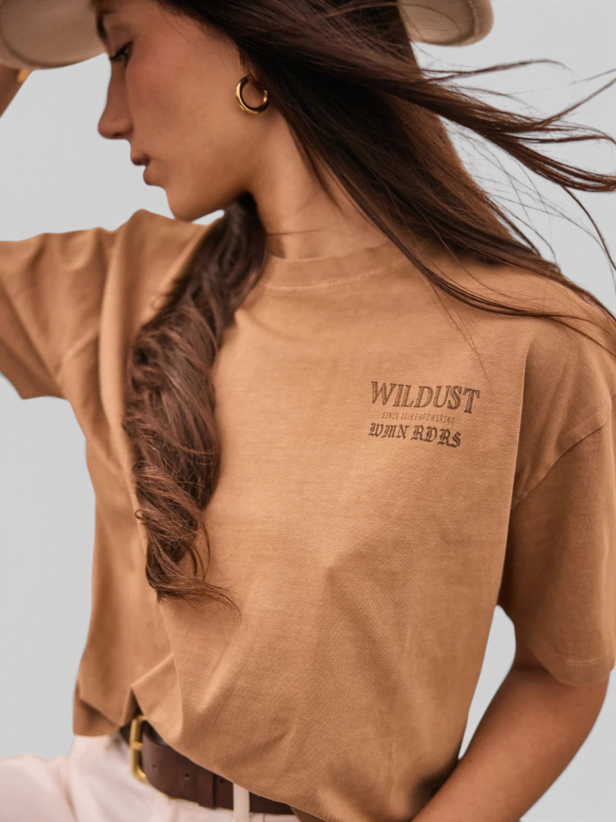 Baffle Haus khaki 100% cotton loose-fit cropped T-shirt with chest graphic print worn by a woman in a hat